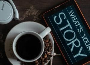 cup of black coffee with a sign What's Your Story