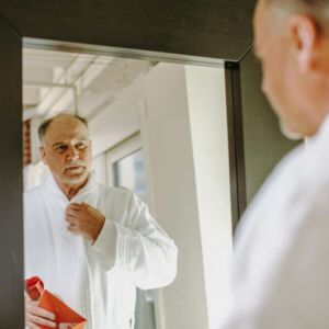 Middle age man looking at mirror - being patient is the key to success