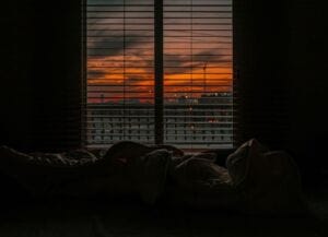 bed with sunset through window - its important to get a good night's rest