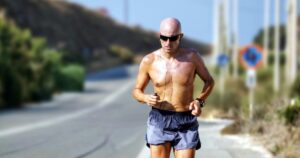 Man running on road demonstrating discipline and focus