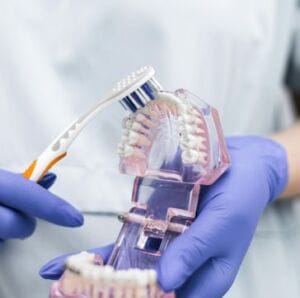 Dentist demonstrating proper brushing
