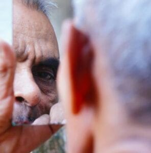 looking at broken mirror - What It Takes to Look Younger